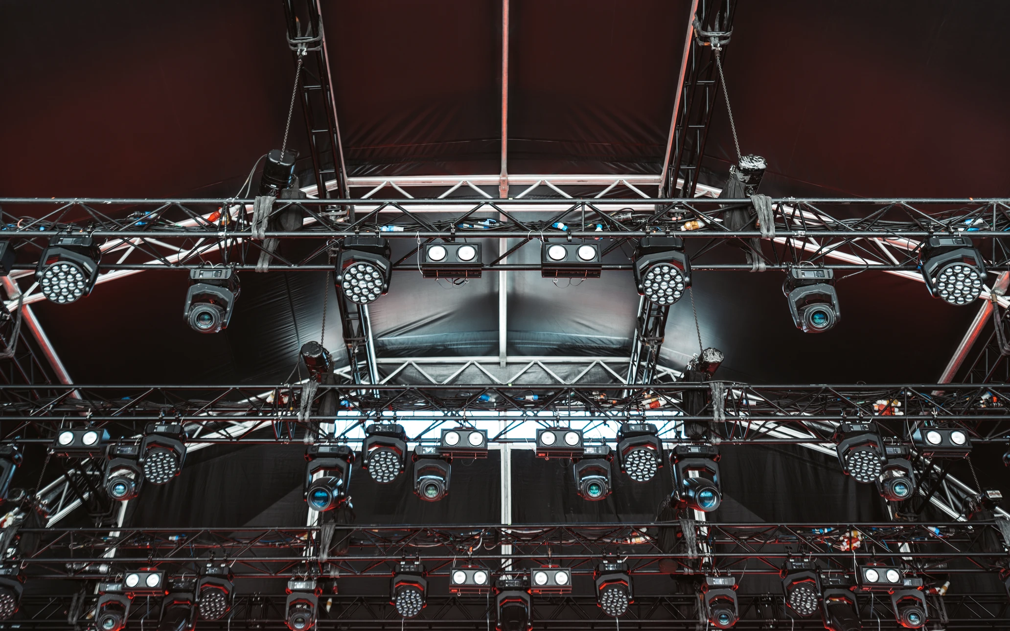 Photographie d'une scène de spectacle en direct avec artistes en performance (musiciens ou danseurs), éclairage professionnel coloré de qualité, public visible en arrière-plan engagé et enthousiaste, moment dynamique d'une animation festive. La scène doit montrer clairement l'action d'une prestation événementielle professionnelle, reflétant l'expertise d'une agence d'animation spécialisée dans les spectacles et animations.